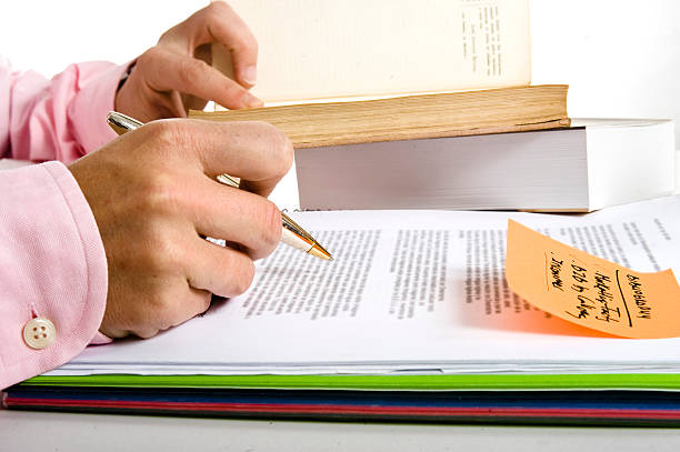 Pen and Pile of books for Study and Research